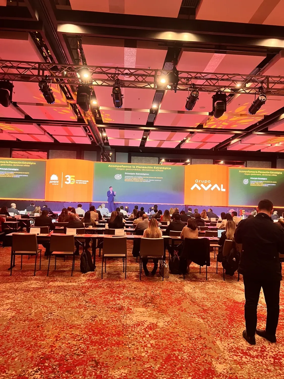 Pantalla LED panorámica en el congreso de aniversario de un grupo empresarial en Bogotá, con público en mesas
