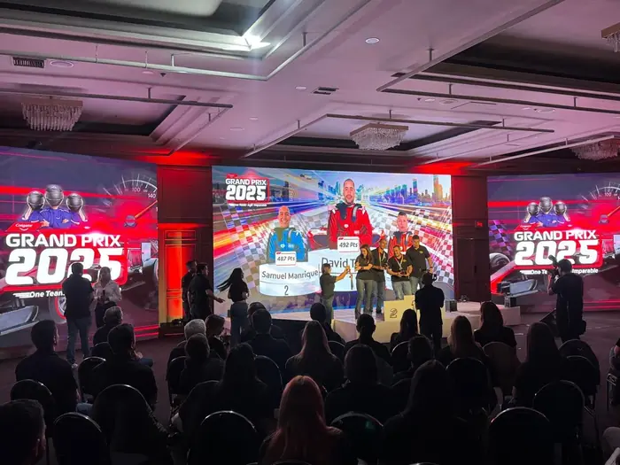 Pantalla LED en un evento corporativo temático con iluminación roja y público de pie